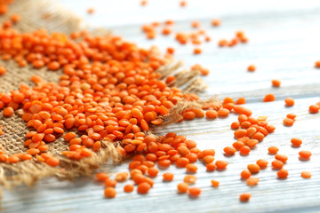 Red lentils on a blue wooden table