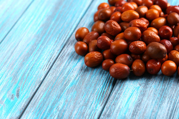 Ripe jujubes on blue wooden table, close up