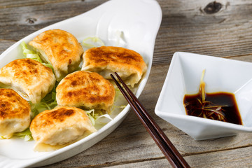 Chinese dumplings with dipping sauce dish ready to eat