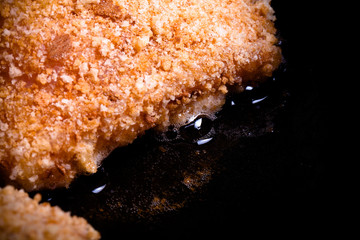 Chicken cordon bleu fried in oil in a frying pan. Selective focu