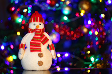 Snowman among festive lights