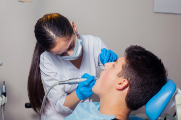 Obraz na płótnie Canvas Man having teeth examined at dentists dental treatment