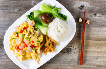 Chinese fried egg and shrimp dish in plate setting ready to eat