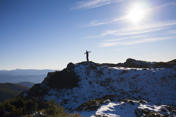 The silhouette of a man in the mountains.