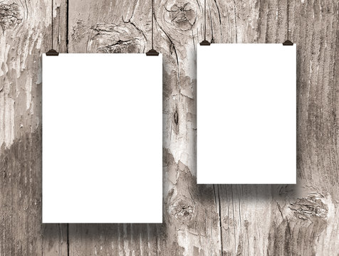 Close-up of two hanged paper sheet frames on wooden background