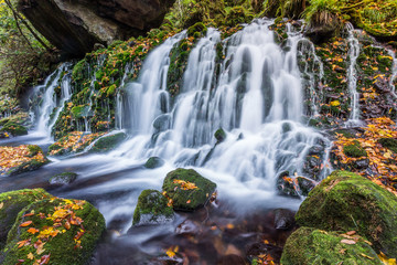 beautiful waterfall in forest, autumn landscape