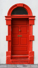 Bright red door in a white wall