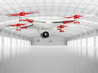 white quadcopter drone with HD camera in flight in interior warehouse