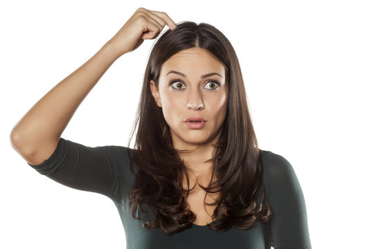 Startled Young Woman Scratching Her Head