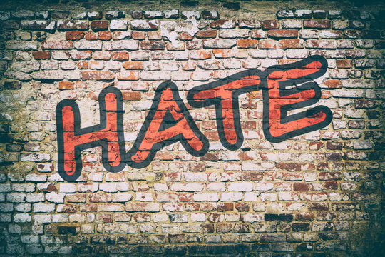 Brick Wall With Word Hate Graffiti.