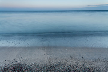 Calm waves rolling in on a beach at dawn at the island of Gotland in the Baltic Sea, Sweden.