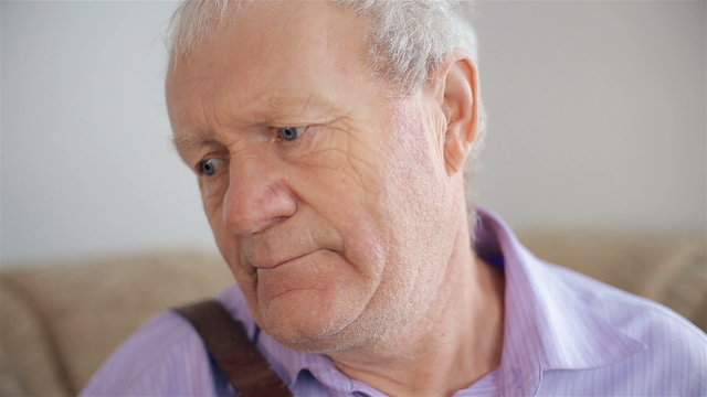 An old man playing the harmonica