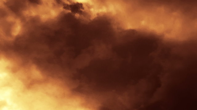 Cloud FX0401: Dark time lapse clouds rise across a deep orange sky (Loop).