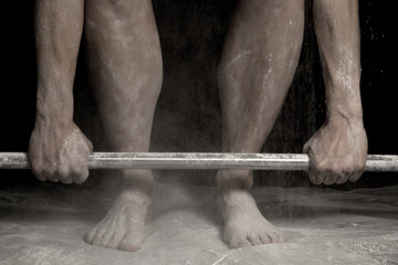 legs and feet with arms holding bar and powder all over