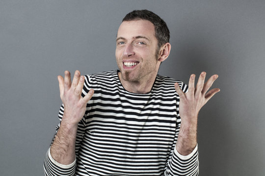 hand gesture concept - happy extrovert 40s man expressing himself with hands talking,studio shot