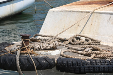 Fototapeta premium Nautical ropes on a rusty small boat, close-up. 