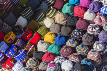 Muslim woman selling hats in a Market stall in the Marrakech sou