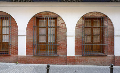 Fototapeta na wymiar White arch with window and brick wall inside