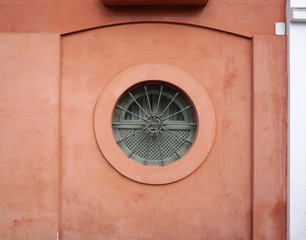 circular window with red wall