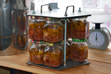glass jars of stew in the cassette after autoclaving