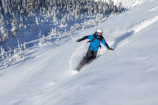 Snowboarder go down mountain slope