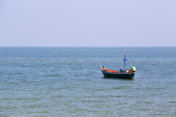 Naklejka premium single mini fishery boat floating on sea