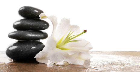 Spa stones with lily, isolated on white