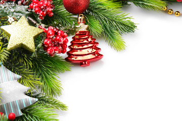 Christmas tree branch with red berries and decorations on white background