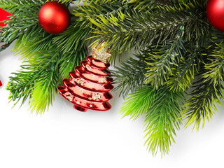 Christmas tree branch with red berries and decorations on white background