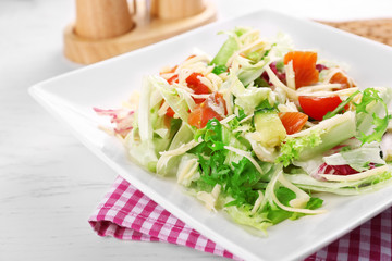 Tasty salmon salad on wooden table background