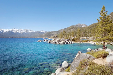 Lake Tahoe shore with blue sky and rocks