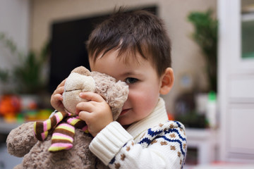 little preschool boy hugging Teddy bear