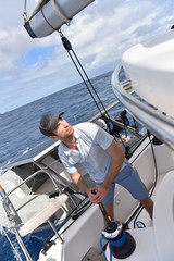 Man pulling sails out for navigation