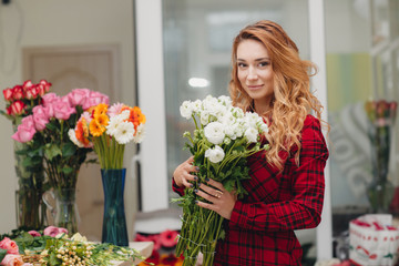 Beautiful female florist in flower shop