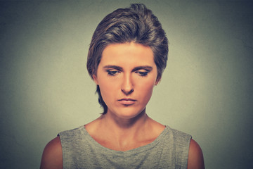 Lonely sad woman deep in thoughts looking down