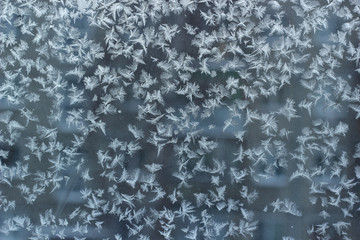 Snowflakes ornament on glass. Winter texture background