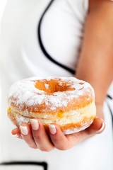 Donut in woman's hand