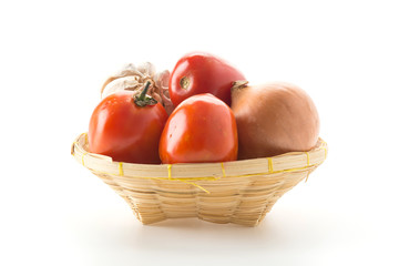 tomatoes, onion and garlic in basket