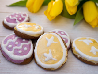 Easter egg shaped cookies and yellow tulips
