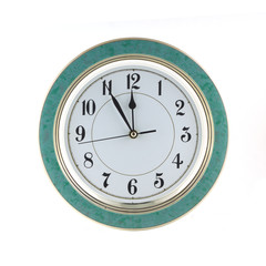 Almost twelve o'clock on big wall clock isolated on white closeup