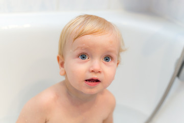 Adorable Little Boy Sitting In The Bath