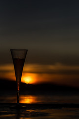 Champagne flute glass against sunset