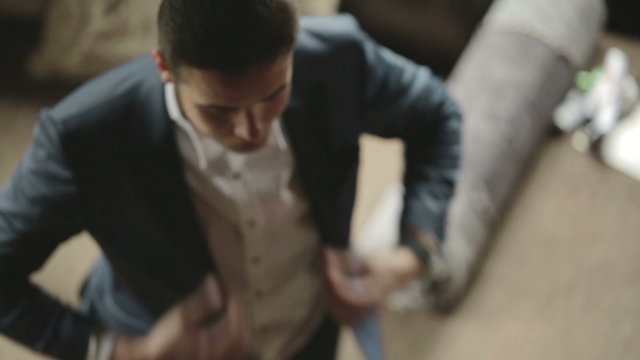 businessman puts a blue jacket
