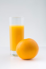 Orange with glassful of fresh juice. 