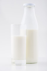 Bottle and glass of milk together. 