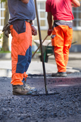 Asphalt surfacing manual labor.