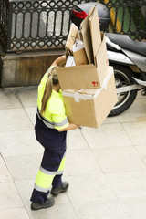  utility service company woman  worker  of  municipality collected cartons for recycling in street city
