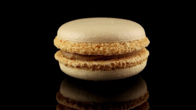 French macaron with coffee flavor (horizontal view with reflection)
