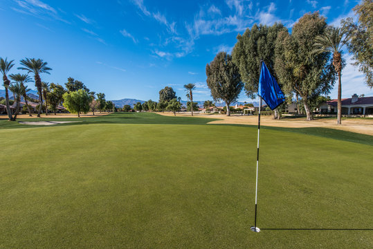 Golf course green with flag in hole