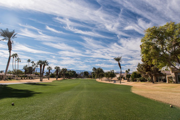 Fototapeta premium Golf fairway is green surrounded by brown rough